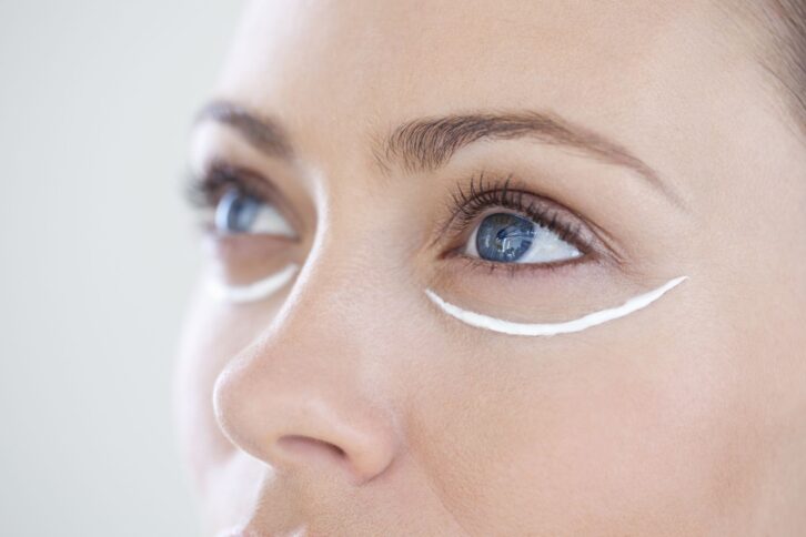 Woman with eye cream