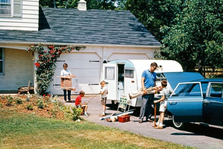 1960s FAMILY FATHER MOTHER SON DAUGHTER LOADING CAR AND TRAILER FOR VACATION SUMMER OUTDOOR