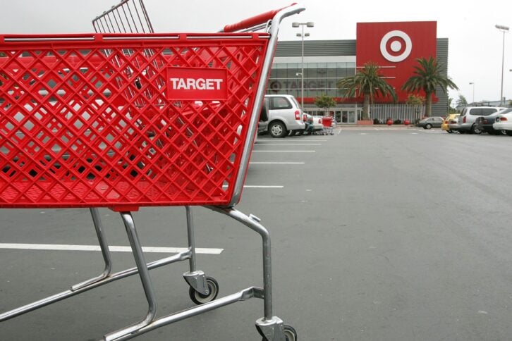 shopping cart stands in the parking lot of a Target store