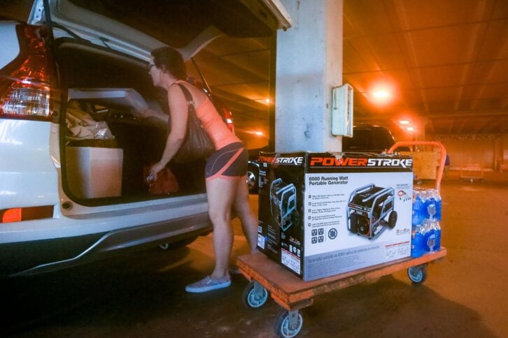 South Florida resident Andrea Kmetz buys a portable generator and bottled water in preparation for Hurricane Matthew on October 5, 2016 in Fort Lauderdale, Florida.