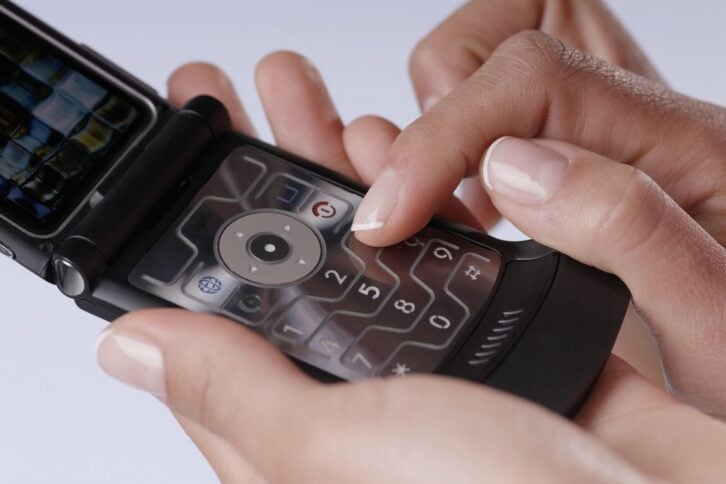 close-up of a woman's finger using a mobile phone