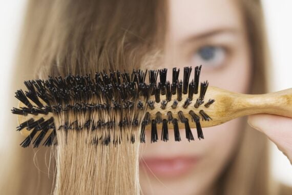 Close up of hairbrush in woman's hair