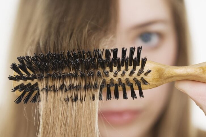 Close up of hairbrush in woman's hair