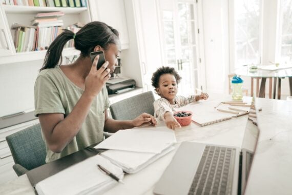 mom is taking a call while her daughter is throwing a tantrum