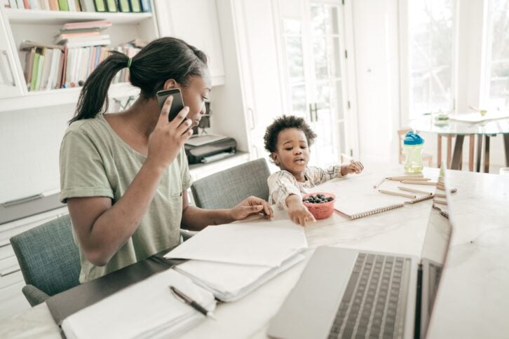 mom is taking a call while her daughter is throwing a tantrum