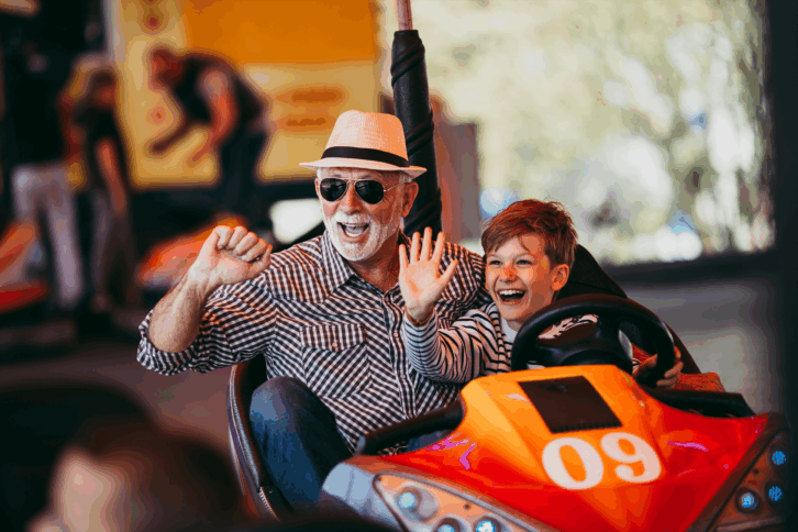 Grandfather and grandson at an amusement park