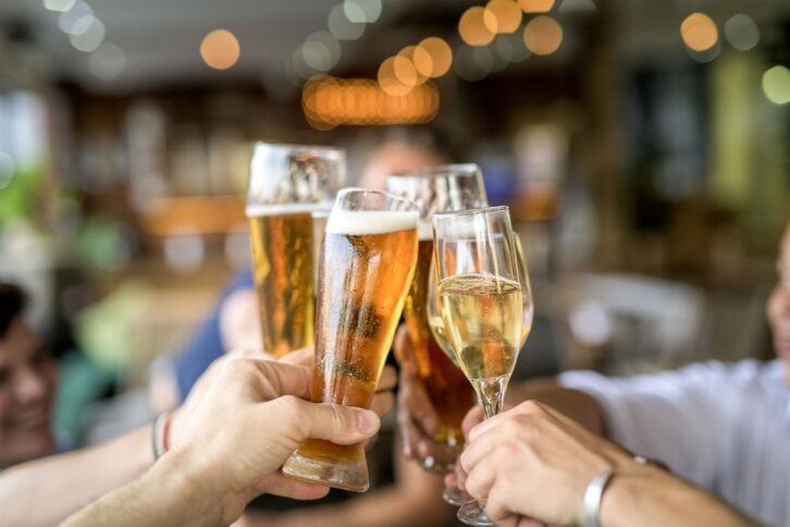 Group of people toasting drinks in a bar