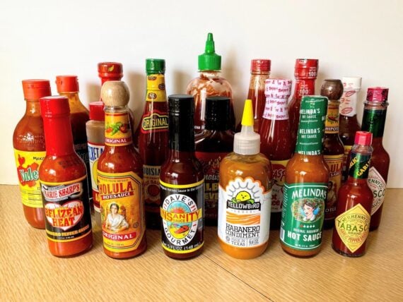 Group of 20 Popular Hot Sauces on Table