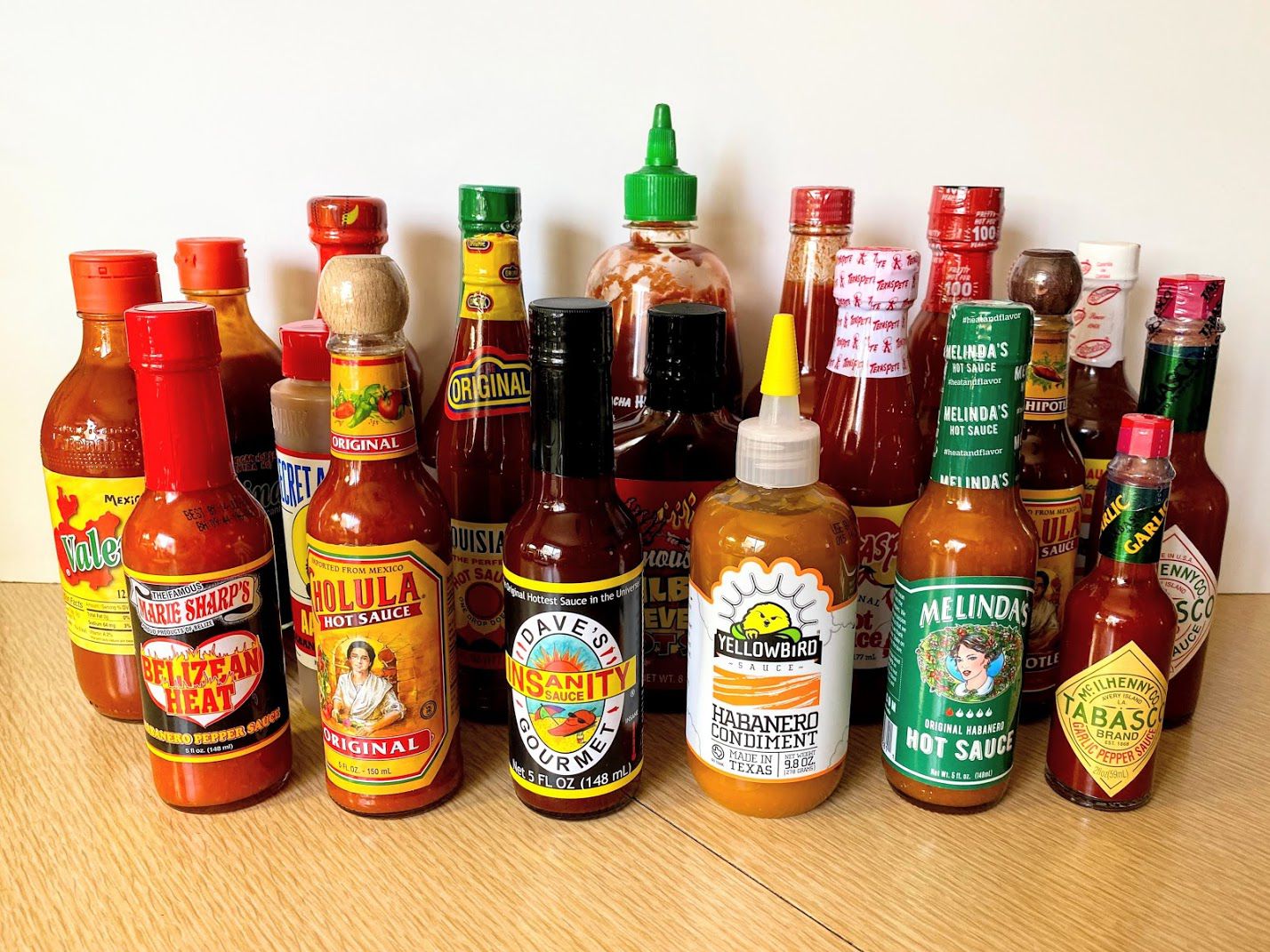 Group of 20 Popular Hot Sauces on Table