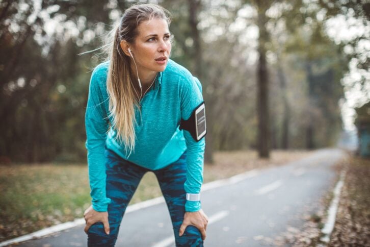 Female runner taking a break to breathe