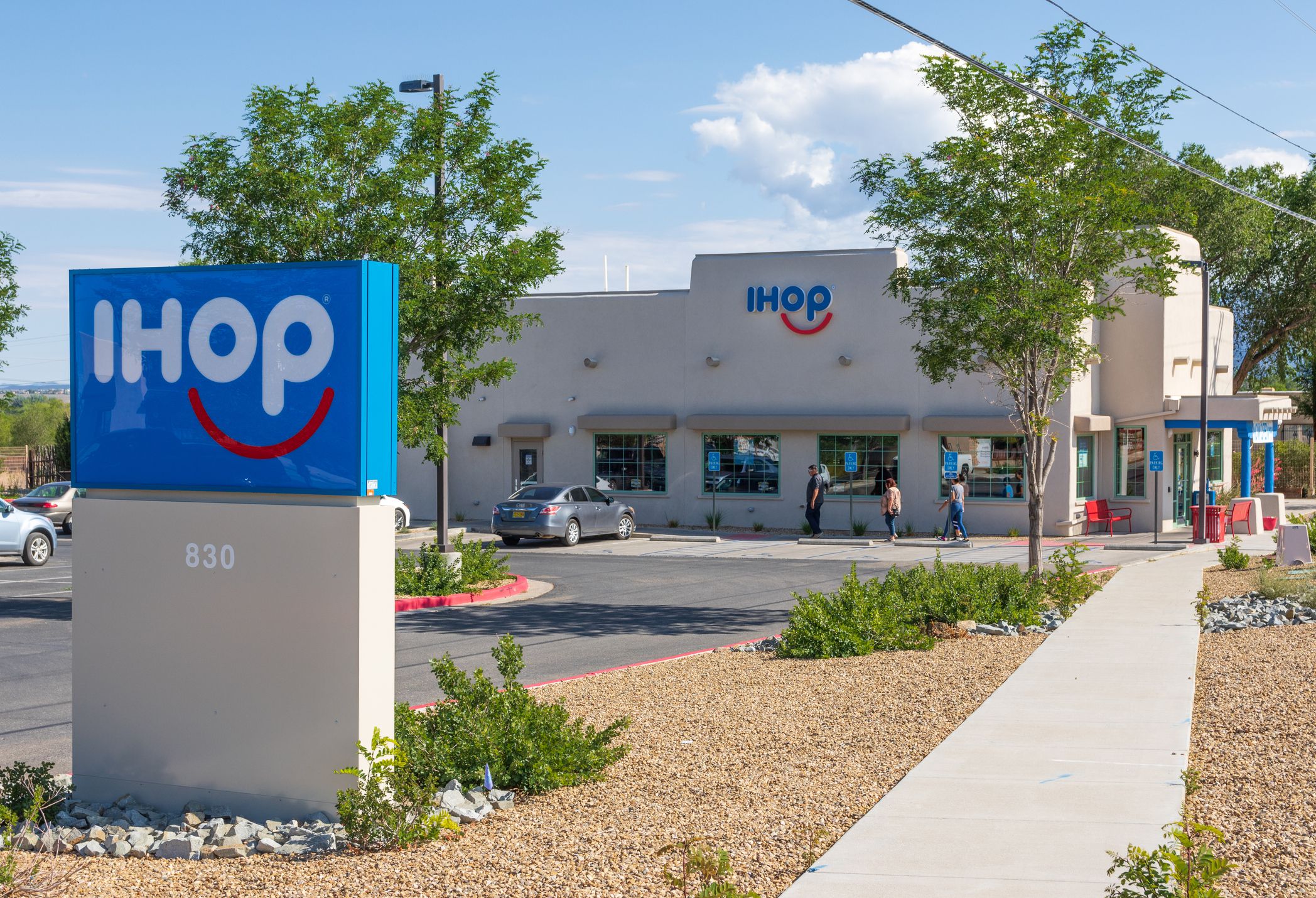 sign in foreground and in background front of IHOP, Taos, New Mexico on a clear sunny day