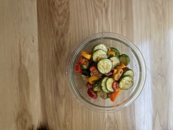 cucumber and mini pepper salad in a glass bowl