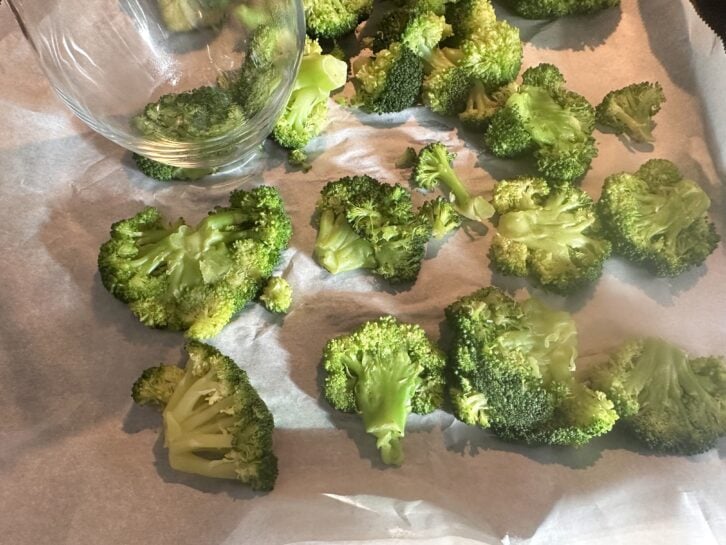 broccoli florets being smashed with a glass