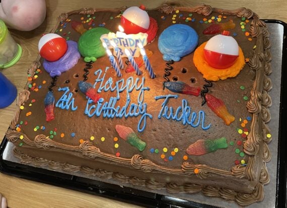chocolate costco sheet cake decorated with gummy fish and plastic bobbers