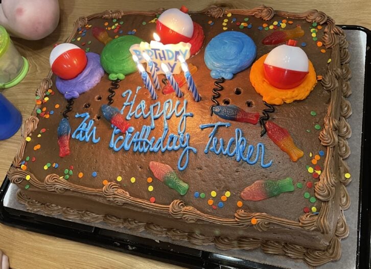 chocolate costco sheet cake decorated with gummy fish and plastic bobbers
