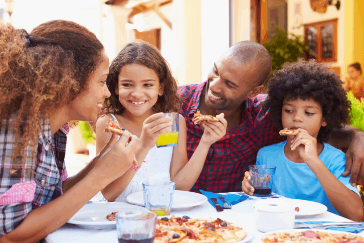 Family eating together at a cafe outside