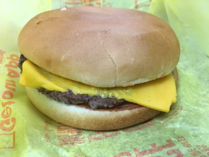 McDonald's Cheeseburger on yellow wax paper