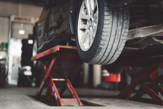 Car in lift at mechanic's auto shop