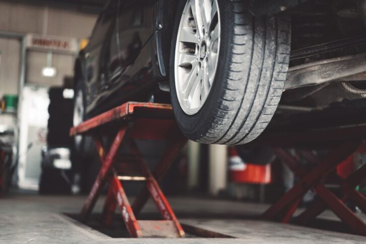 Car in lift at mechanic's auto shop