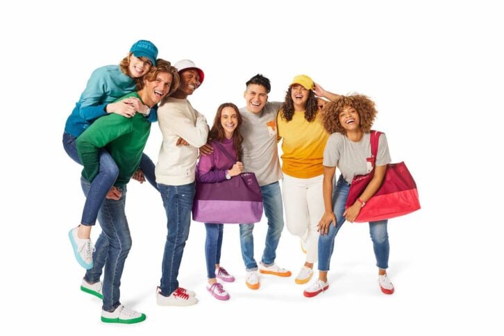 Group of smiling models featuring Chick-fil-A's new line of merchandise.