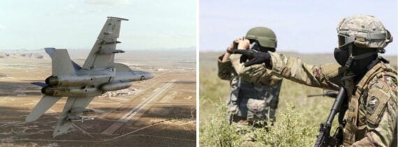 A fighter plane, two soldiers in camouflage looking at a field