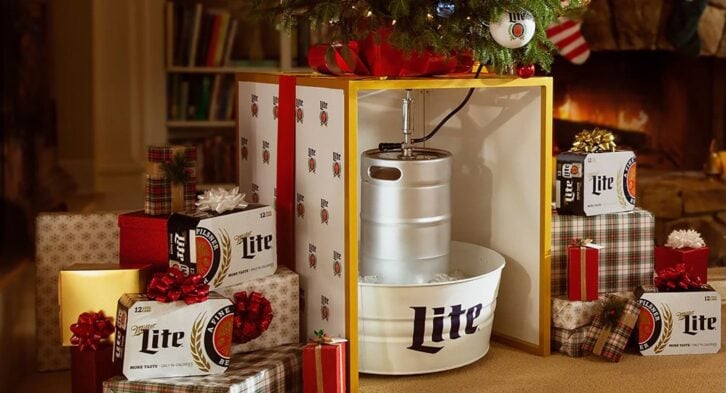 Christmas Keg Stand from Miller Lite under a Christmas tree with wrapped presents