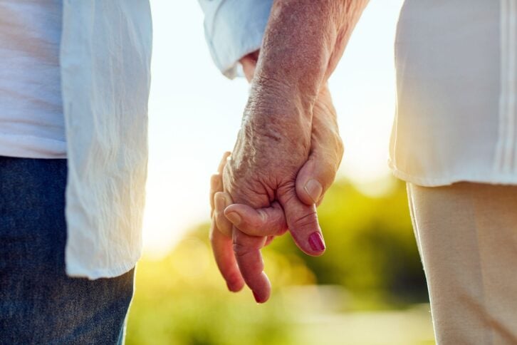 Closeup of seniors holding hands