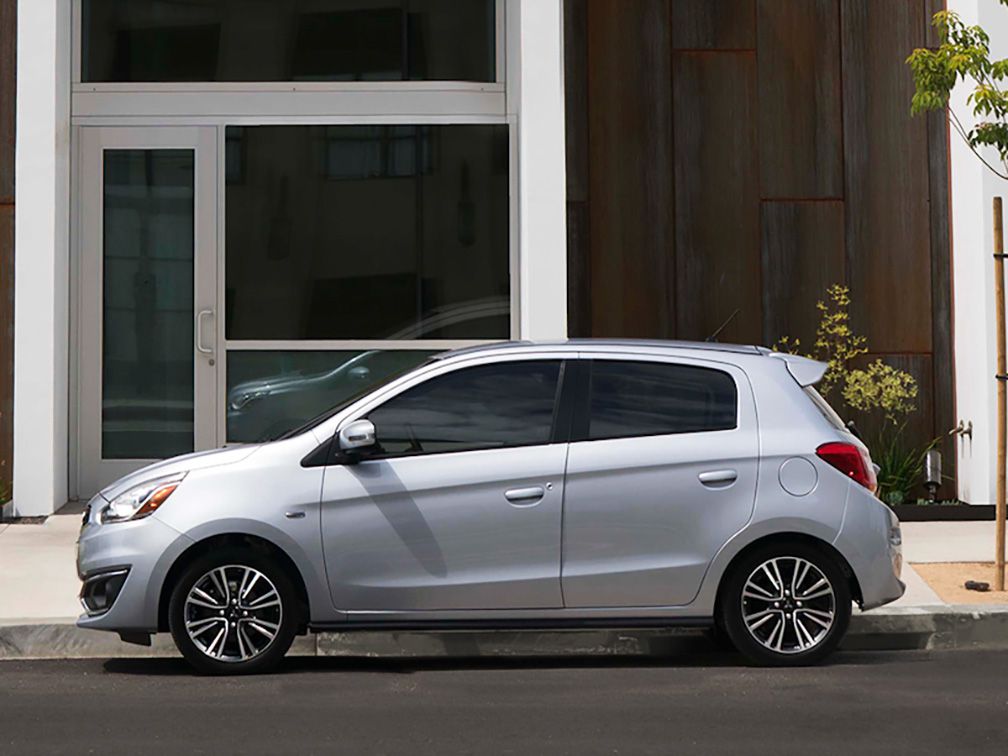Silver Mitsubishi Mirage hatchback parked on city street
