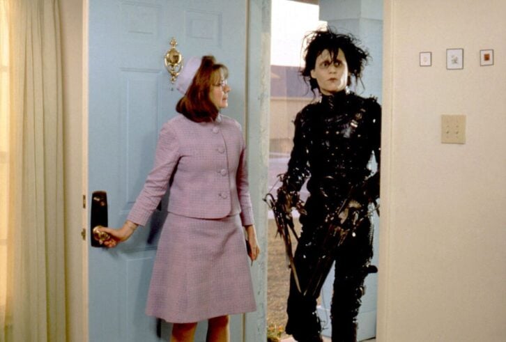 American actors Dianne Wiest and Johnny Depp on the set of Edward Scissorhands, Wiest is opening the door and Depp is walking through it