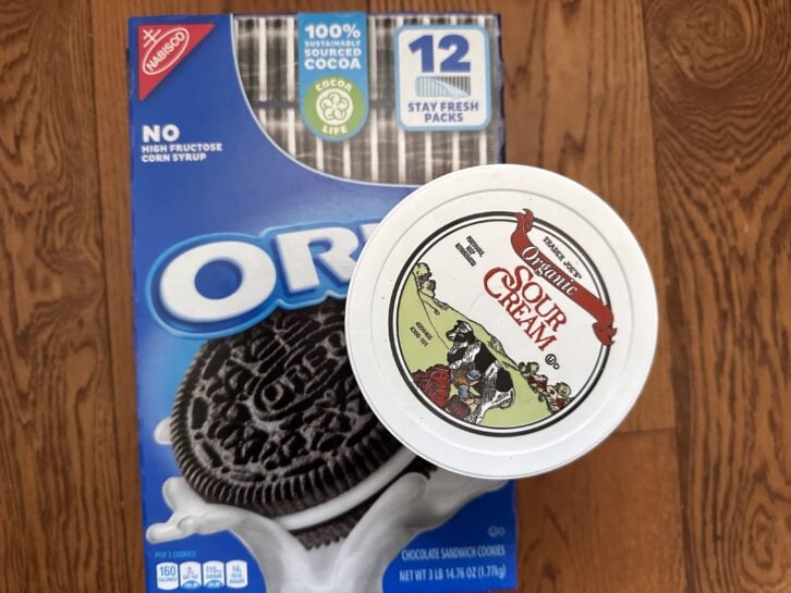 A box of  Oreos next to a container of Trader Joe's organic sour cream
