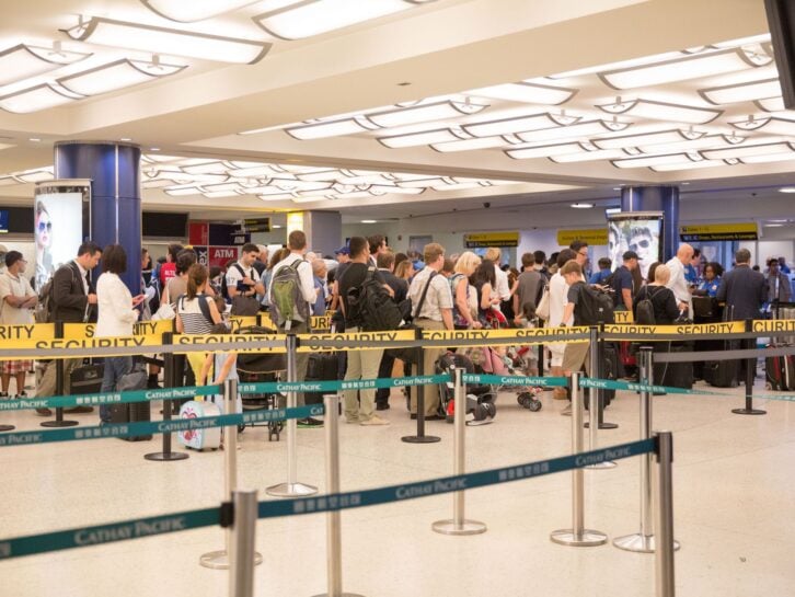 New York City, United States-July 1, 2014: A long line of passengers wait patiently to pass through airport security at a terminal at John F. Kennedy International Airport in New York City. All of these travelers must clear security before being allowed t