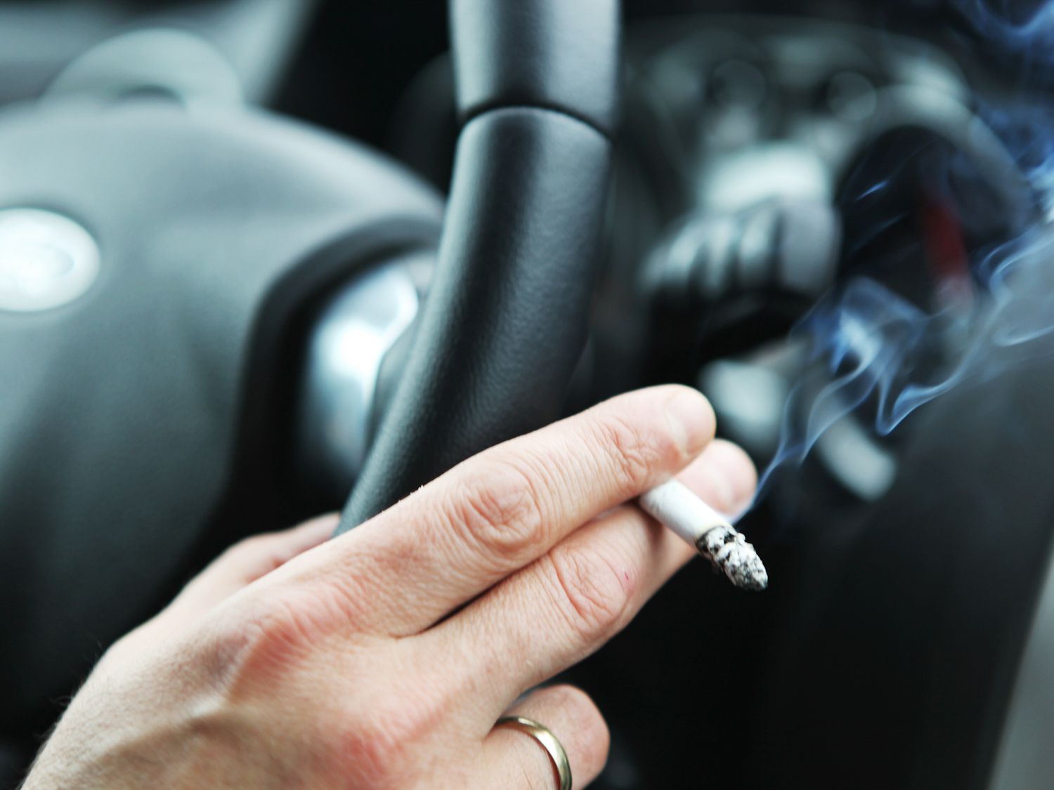 Man smoking in car.