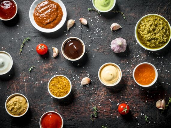 Different types of sauces. On dark rustic background
