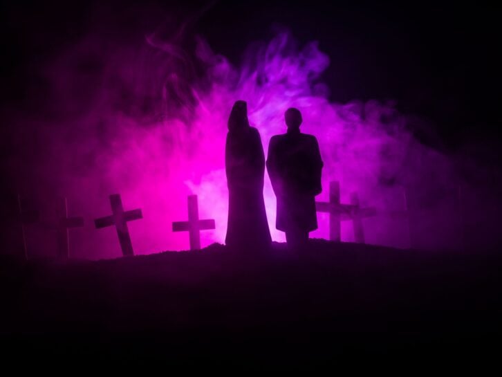 Horror Halloween concept. Scary zombie bride on a night cemetery.