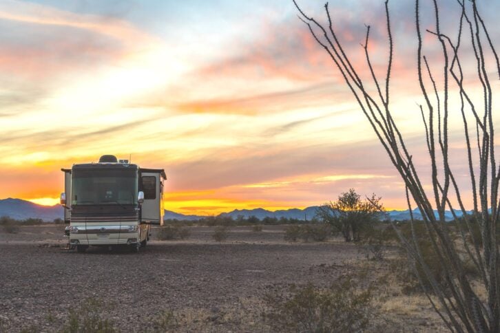 RV is parked on lot, Quartzsite, Arizona with sun setting