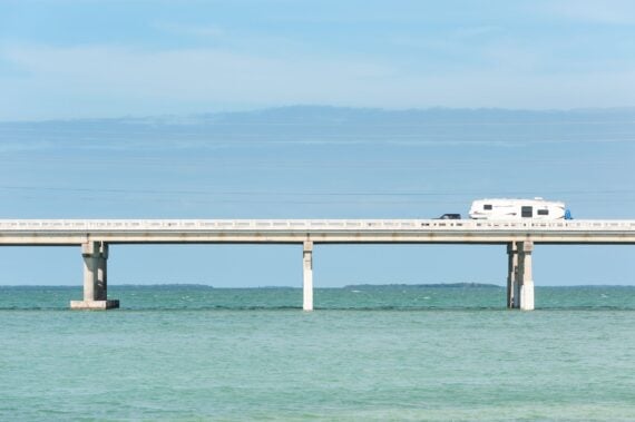 RV traveling on Seven Mile Bridge of Overseas Highway between the Florida Keys with the ocean and sky