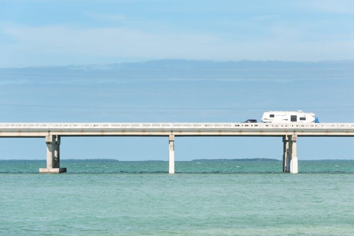RV traveling on Seven Mile Bridge of Overseas Highway between the Florida Keys with the ocean and sky