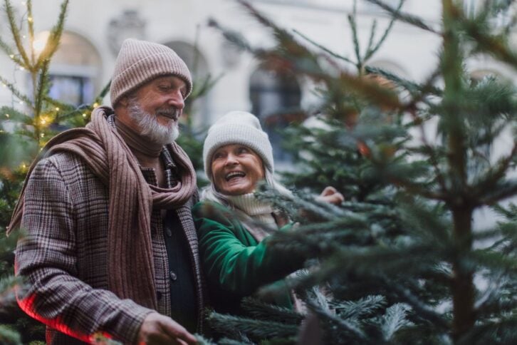 Two seniors picking out a christmas tree
