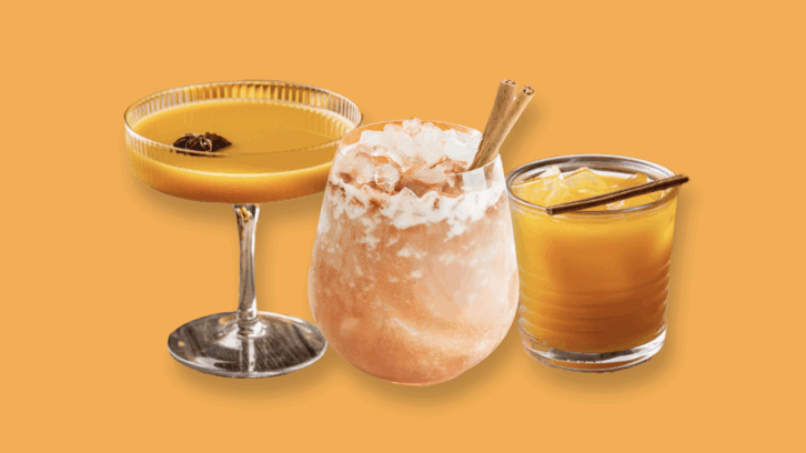 A trio of pumpkin flavored cocktails against a pumpkin colored background.