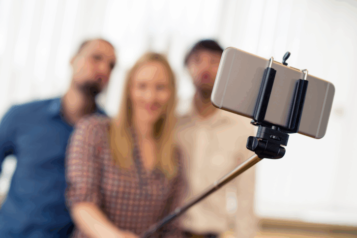 Group of friends using a selfie stick