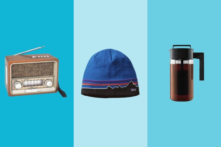 Three gift items on tri-toned blue hues, a retro radio, a Patagonia beanie, and a cold brew coffee maker