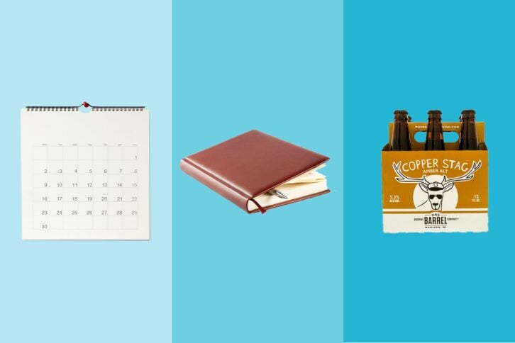 Three gift items on tri-toned blue hues, a wall calendar, a brown leather journal, and a six pack of Copper Stag beer
