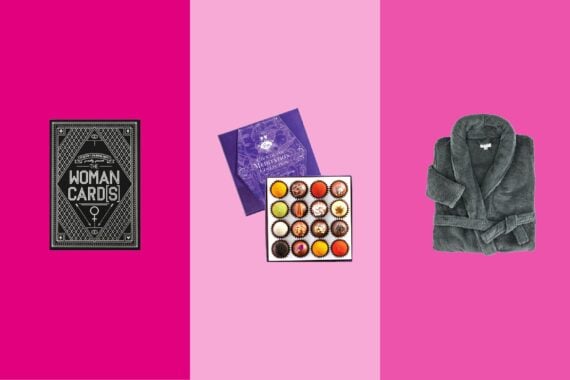 Three gift items on tri-toned magenta pink hues, Woman Cards, a box of Vosges Haut-Chocolat chocolates, and a Gravity robe