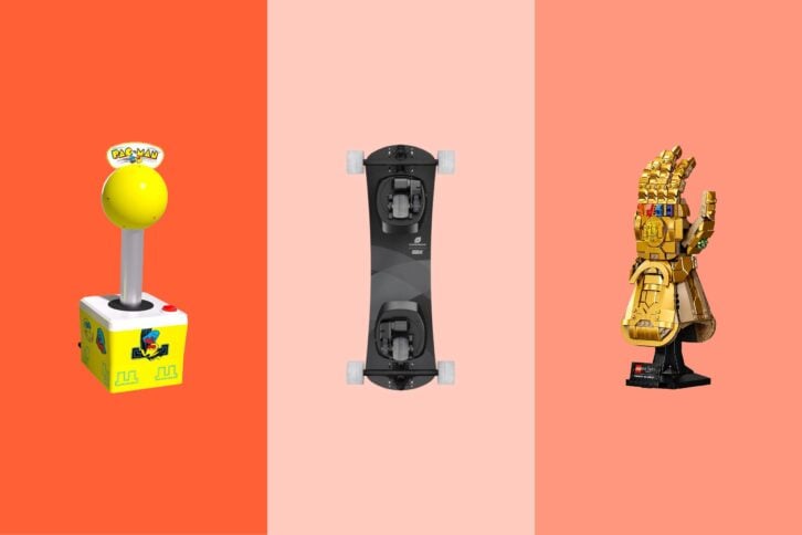 Three gift items on tri-toned salmon hues, a Pac Man giant joystick, a skateboard, and a LEGO golden hand