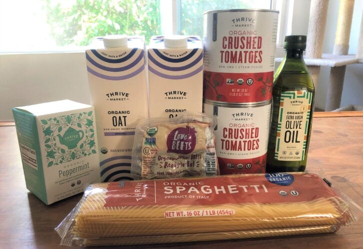Products from Thrive Market, including crushed tomatoes, oat milk, spaghetti, and more