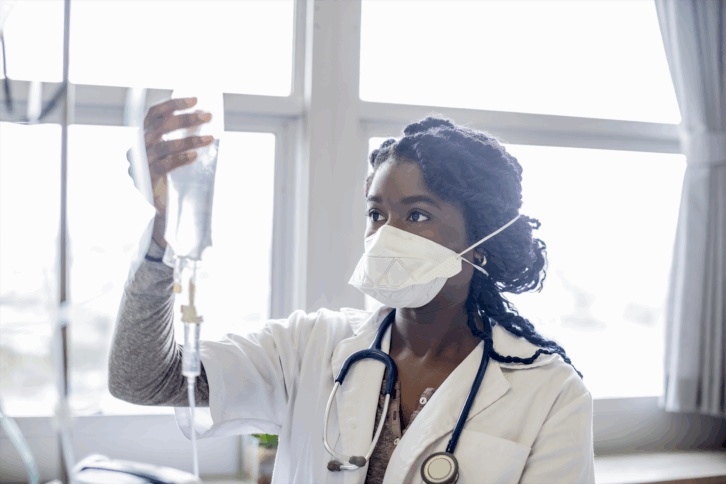 nurse checking IV bag