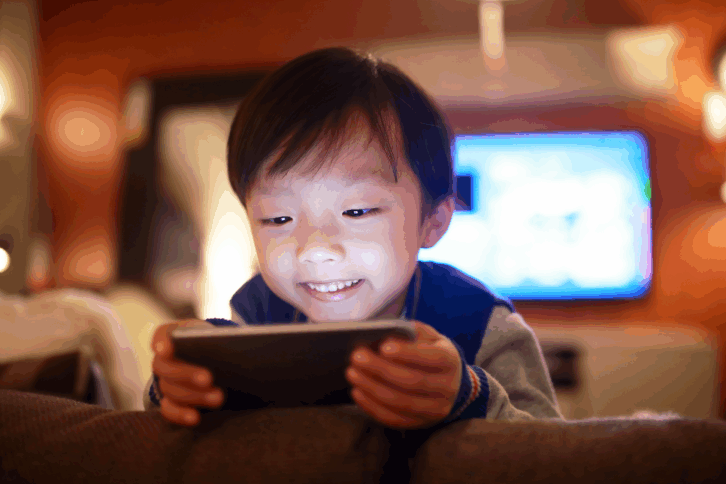 Young boy watching something on a smartphone