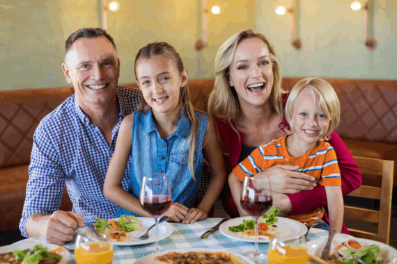 Happy family eating together at a resaurant