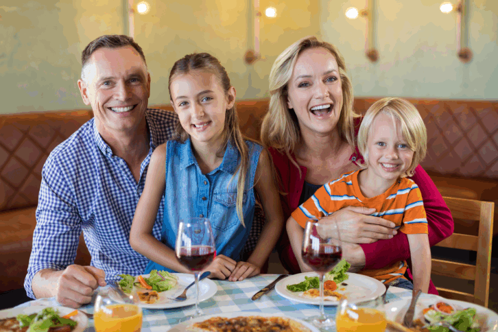 Happy family eating together at a resaurant