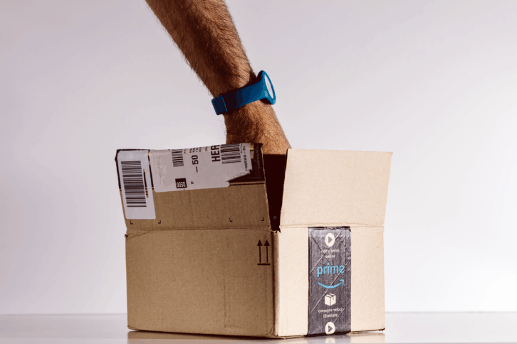 Man's hand reaching into an Amazon Prime box